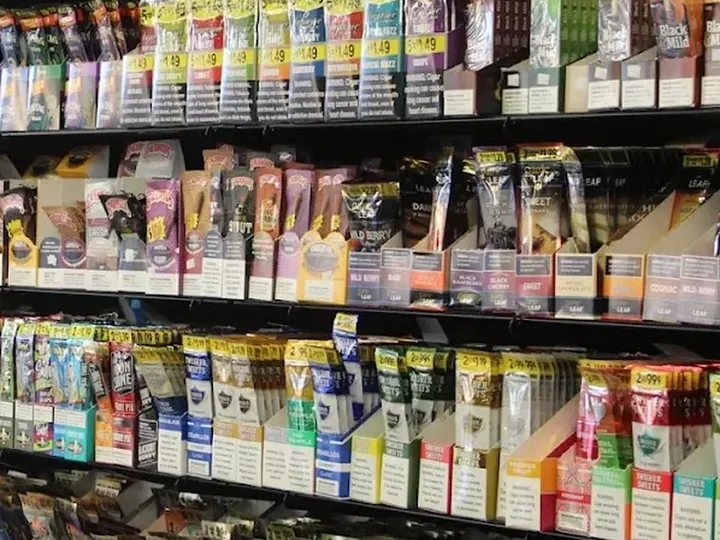 Shelves of cigarillo and wrap packs stacked in display trays